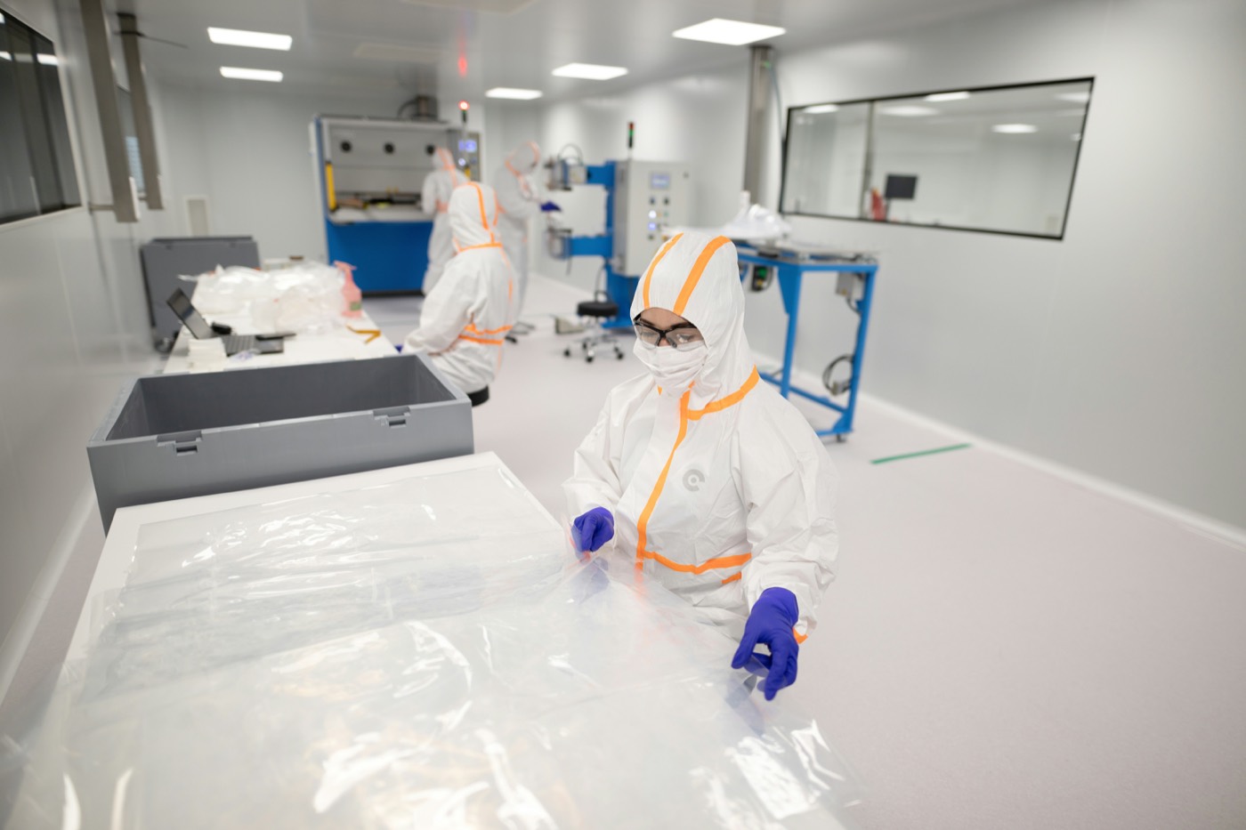 Cleanroom operators handling sterile pharmaceutical materials